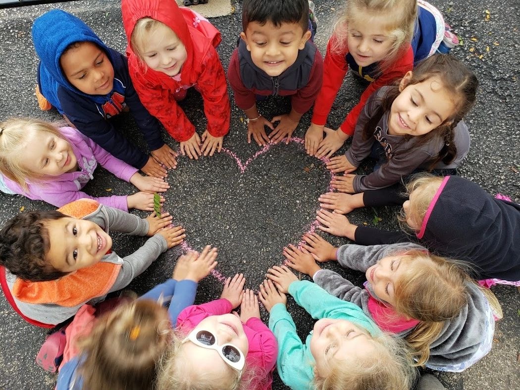 Group of young children in a circle outdoors